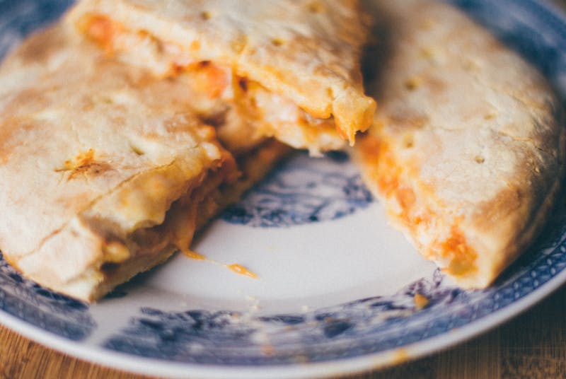 Golden baked calzone stuffed with cheese and meat