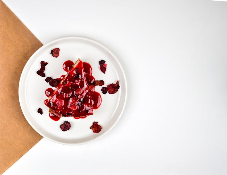 New York style cheesecake slice with berry compote