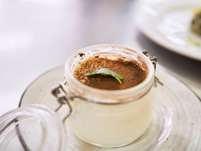 Tiramisu dessert in glass with cocoa dusting